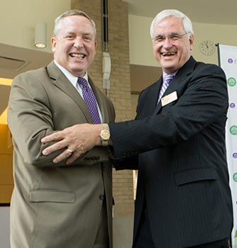 GHS president and CEO Mike Riordan (left) and Furman interim president Carl Kohrt at a recent event announcing that Furman would join the GHS as its undergraduate partner.