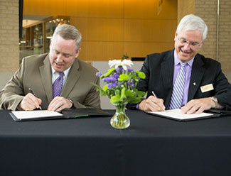 GHS president and CEO Mike Riordan (left) and Furman interim president Carl Kohrt signed the agreement in the fall of 2013 creating the academic partnership between the two institutions.